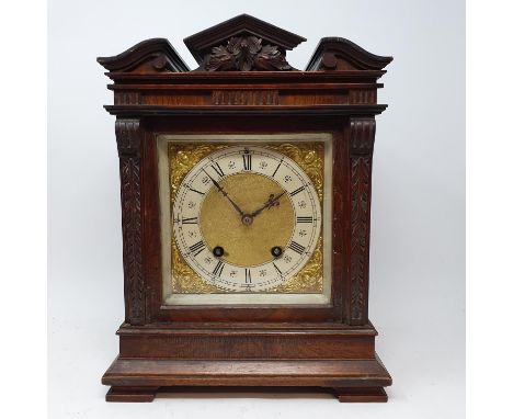 A mantel clock, the dial with Roman numerals, having a twin train movement, in walnut case, 24 cm wide, and three other clock