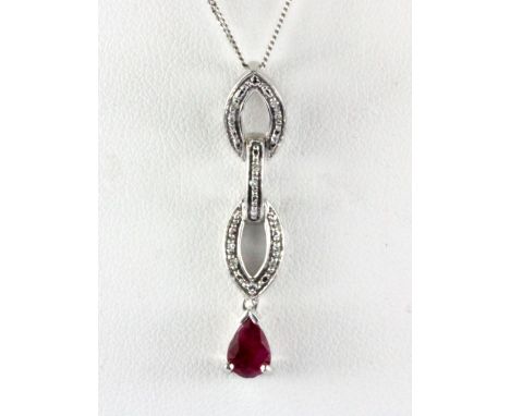 A 9ct white gold ruby and diamond set pendant and chain, L. 3.5cm.
