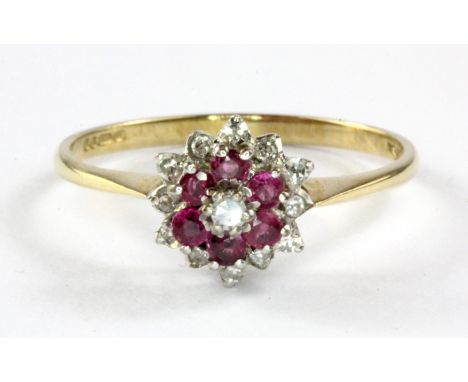 A 9ct yellow and white gold ruby and diamond set cluster ring, (P.5)