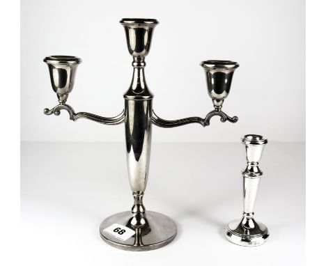 A hallmarked silver three branch candelabrum, H. 25cm together with a single hallmarked silver candlestick.