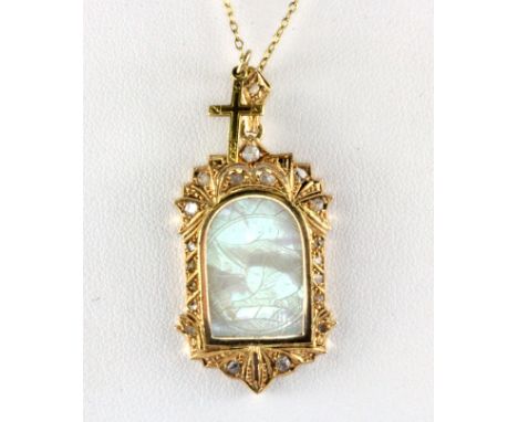 A yellow metal (tested 18ct gold) pendant set with diamonds and carved mother of pearl on a 9ct gold chain.