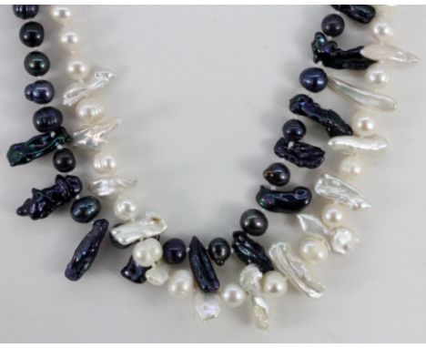 Two black and white pearl and baroque pearl necklaces, L. 44cm.
