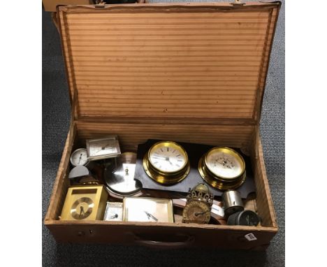 A vintage case of clocks and barometers.