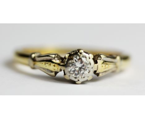 An 18ct yellow and white gold diamond set solitaire ring, (K).