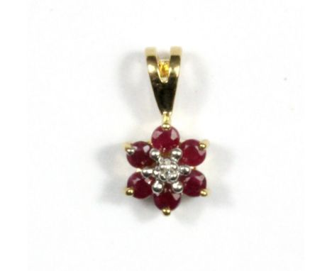A 9ct yellow gold ruby and diamond set pendant, L. 1.2cm.