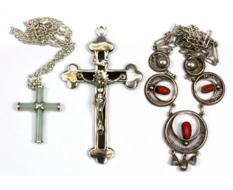 A white metal mounted jade cross pendant and chain, a further white metal cross pendant and an Easter white metal necklace.