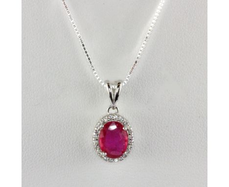 A 925 silver ruby and white stone set pendant and chain, L. 2cm.