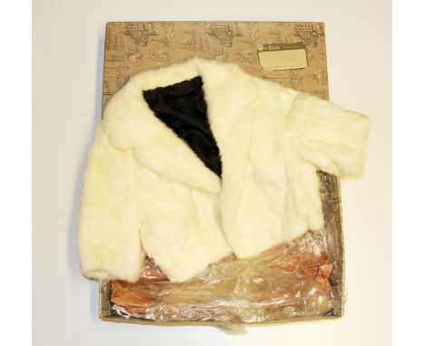 A vintage blonde mink cape in a Harrods box.