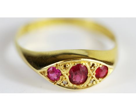 An 18ct yellow gold ruby and diamond set ring, (two diamonds missing), (P).