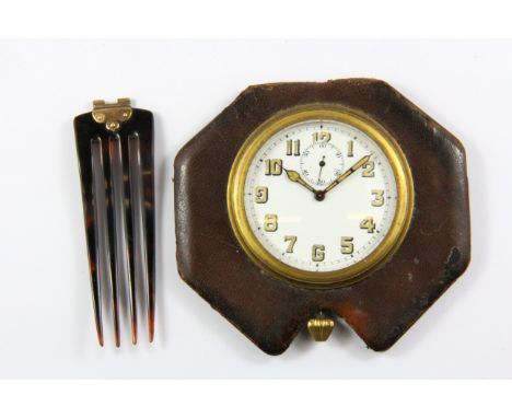 A vintage travel clock, Dia. 6cms with a rose metal mounted tortoiseshell hair comb.