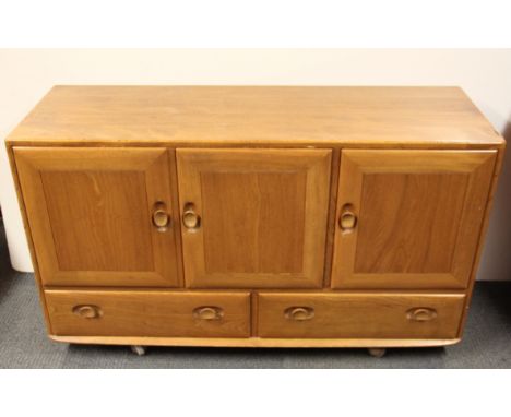 A 1970's light oak Ercol type side board, W. 130 H.76cm.