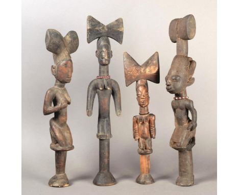 Four Yoruba Shango wands Nigeria wood, with kneeling female devotees with thunder axe crests, two with red and white glass be