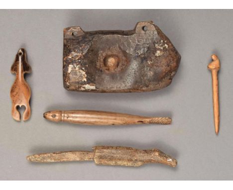 λ  Five Inuit artefacts Alaska including a walrus ivory drill cap, with two attachment lugs and a central recess, 9cm long; a