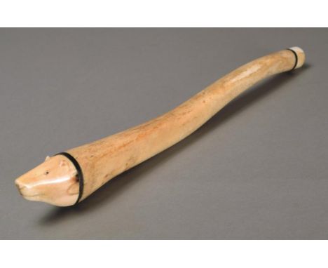 λ An Inuit Oosik club Alaska walrus baculum, penis bone, baleen and walrus ivory, with a carved polar bear head finial, 19th 