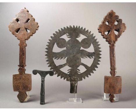 An Ethiopian prayer staff finial brass of pierced T form and with cross decoration, 17cm high, two Ethiopian wood Coptic cros