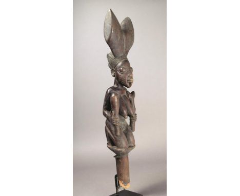 A Yoruba Shango wand Nigeria wood, the naked kneeling female holding a rattle shere and staff, her face with scarifications, 