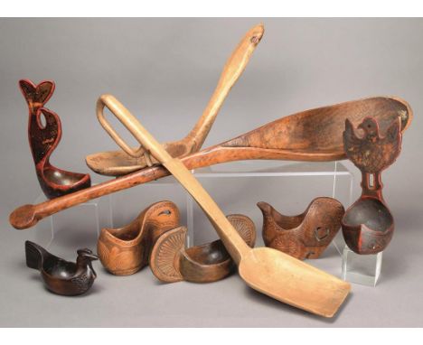 A collection of nine cups and ladles Russia and Scandinavia wood, including two lacquered with bird handles, two with chip ca