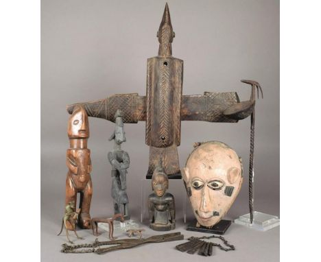 A Nigerian mask wood with paint and remains of cloth, 23.5cm high, a Bambara door lock, two Yoruba figures, a standing figure