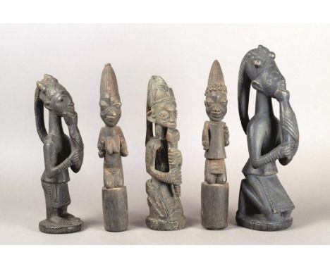 Five Yoruba Eshu figures NIgeria wood, including a pair of male and female staffs, the kneeling figures holding gourds and a 