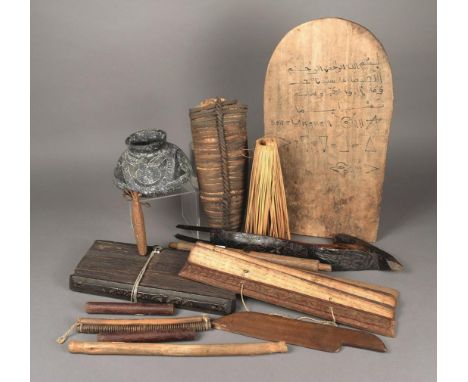 A North African writing board wood with text and images, 46.6cm high, bound salt money, a wood axe shaft, a pottery vessel, a