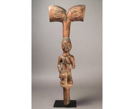 A Yoruba Shango wand Nigeria wood, the kneeling female with a divided coiffure, facial scarifications, with a thunder axe cre