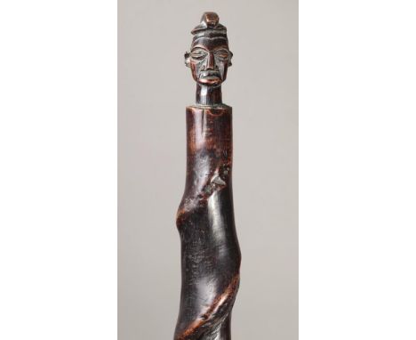 A Yaka staff Democratic Republic of Congo wood with a head finial having a crested coiffure, on a spiral shaft, 64.5cm long, 