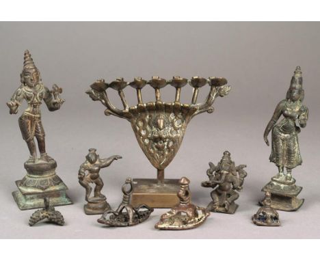 A Tibetan oil lamp brass with the serpent deity supporting seven reservoirs, with painted inventory number 7282, 8cm high, on