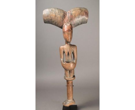 A Yoruba Shango wand Nigeria wood, with a kneeling female holding an offering bowl, with a thunder axe crest and a reel type 
