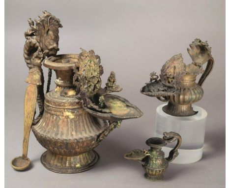 A Tibet oil lamp sukunda brass and copper, with various deities, including the seven headed cobra handle, the foot with inscr
