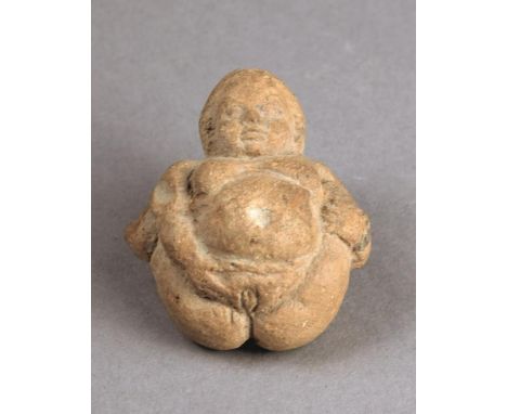 A Hellenistic terracotta figure of Baubo represented as a fat woman with her legs raised back and with her right hand pointin