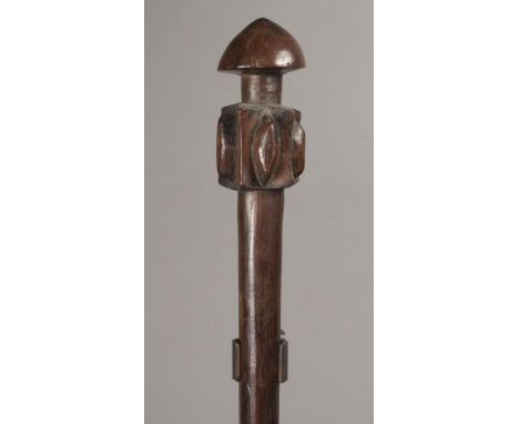 A Vanuatu club Melanesia wood with a capped finial and a star and lozenge head on a cylindrical shaft with a base flange and 