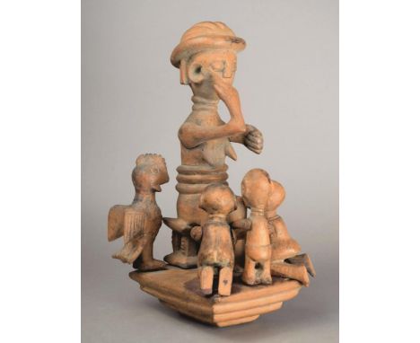 An Ashanti staff finial group Ghana wood, the stepped platform with articulated figures of a mother sitting on a stool and po