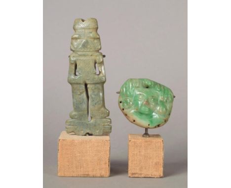 A Mayan amulet Mexico jadite, carved a mask with headdress and disc earrings, pierced for attachment, the back with white pai