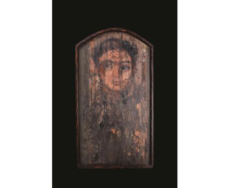 A Romano-Egyptian fayum portrait of a young man circa 1st - 2nd century AD and later painted on wood, with short black hair a