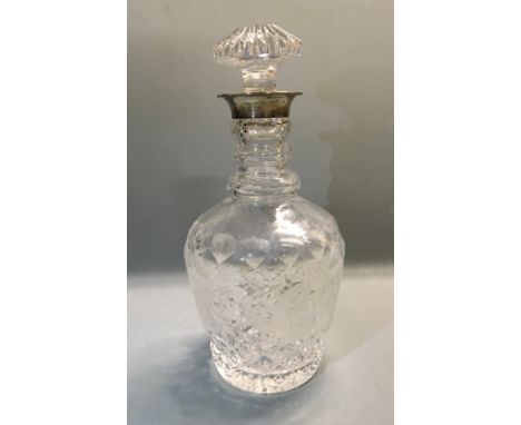 A 1980s cut glass decanter with silver collar.