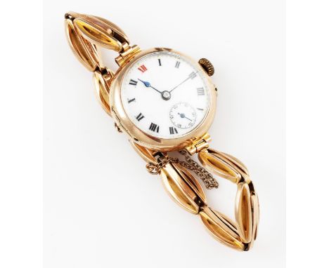 A ladies 9ct yellow gold cased wrist watch, the white enamel dial having hourly Roman numeral markers with minute track borde