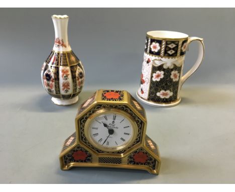 A Royal Crown Derby Old Imari mantel clock and orchid vase, with a Traditional Imari tankard.