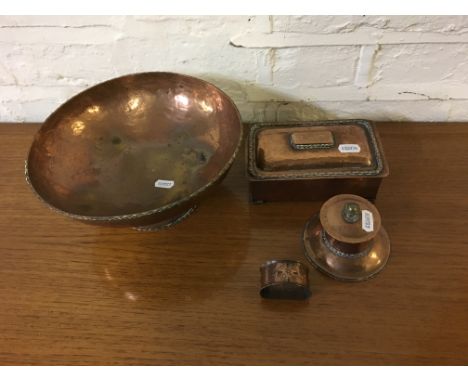 Copper hand beaten arts and craft ware to include bowl, lidded cigarette box, inkwell and napkin ring.