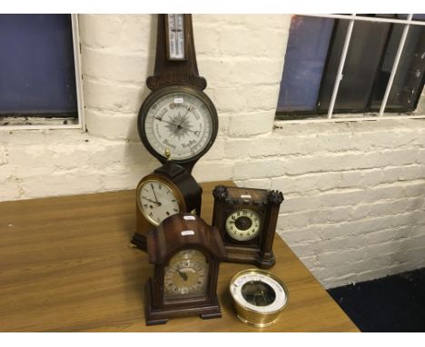 Four various clocks, one in the form of a castle, with a barometer.