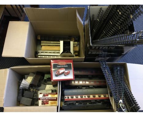 A selection of model train carriages, other vehicles, train tracks, spare parts, etc.
