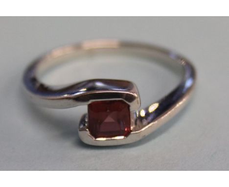 A 9ct white gold and garnet ring, size 'N'