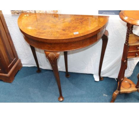 A walnut Queen Anne style half moon and crossbanded fold over card table, 77cm wide