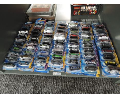 A shelf containing 140 Mattel Hot Wheels diecasts all in blister card packs including 2008 40 year anniversary editions