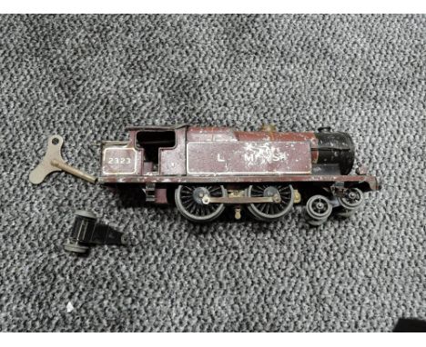 A playworn Hornby 0 gauge clockwork 4-4-2 LMS Locomotive 2323 with key