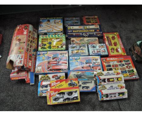 A shelf of modern diecasts and accessories including Matchbox Smash N Crash, Streak Racing Track, Action Pack Convoy, Super C