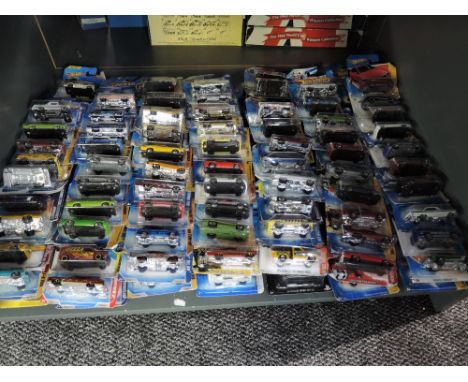 A shelf containing 140 Mattel Hot Wheels diecasts all in blister card packs including 2008 40 year anniversary editions