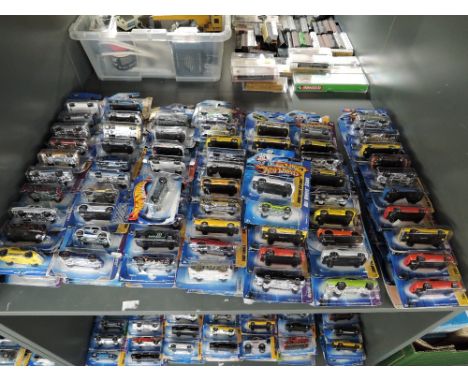 A shelf containing 140 Mattel Hot Wheels diecasts all in blister card packs including 2008 40 year anniversary editions