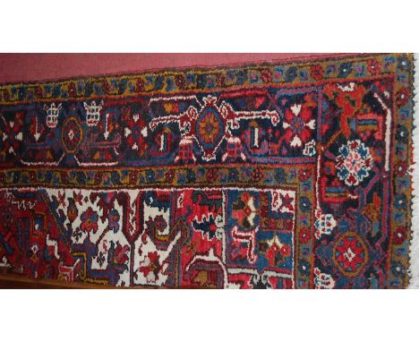 A Persian red ground woollen rug, having an all-over geometric floral trailing ground, 300 x 196cmCondition report: Colour is