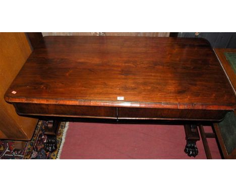 An early Victorian rosewood round cornered two-drawer hall table, raised on shaped and pierced end cut supports to paw feet, 