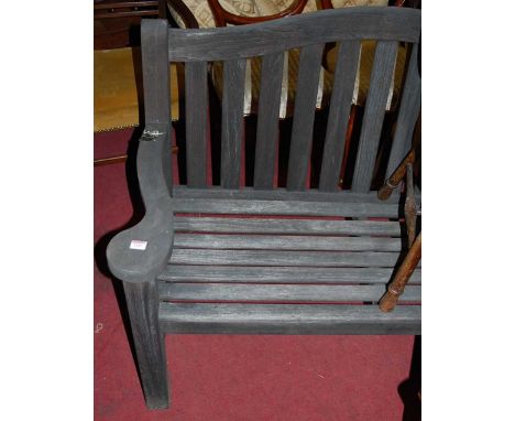 A contemporary stained and slatted teak two-seater garden bench, width 130cm
